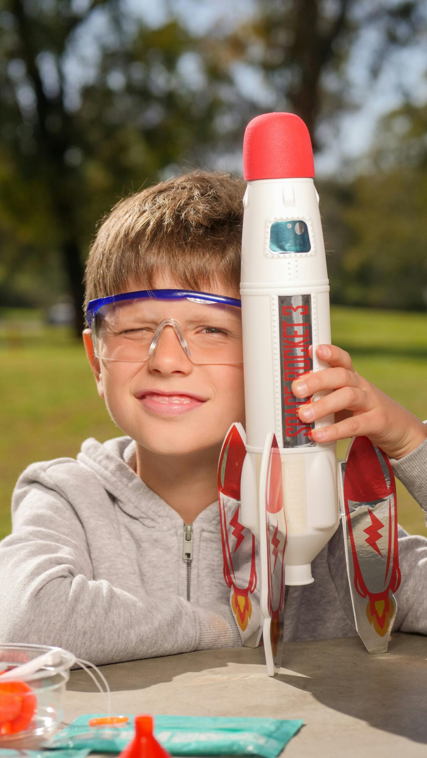 Boy with model rocket and safety goggles
